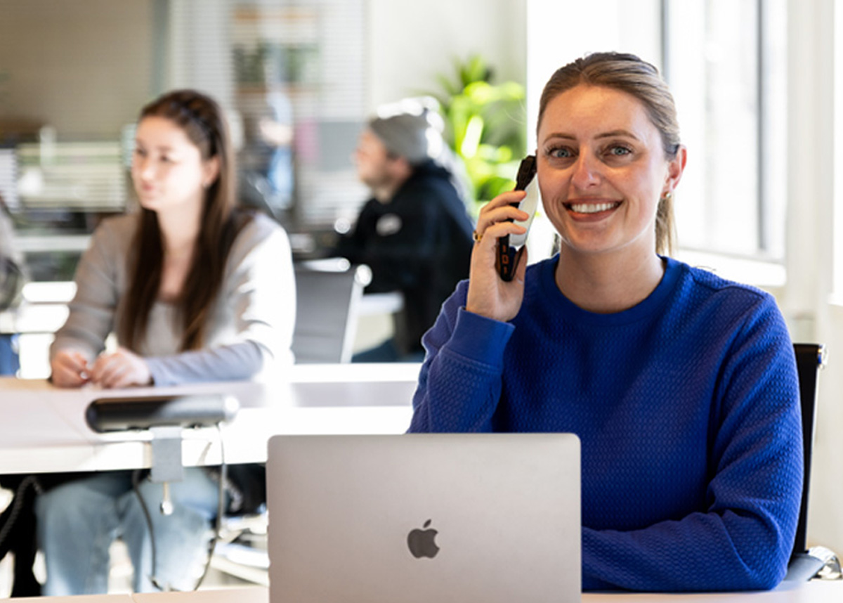 VoIP support agent wearing a headset at a laptop